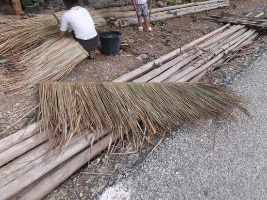 Als ich langsam zum Bike zurück kam, waren an der Strasse 3 junge Mädchen daran, diese Dinger anzufertigen. Ich stelle mir vor, dass sie für die Dächer ihrer Häuser gebraucht werden. 
So, nun musste ich wieder weiter. Ich setzte mich aufs Bike und stampfte den Berg hoch. Es was eine kurze Pass-Strasse. In ca. 15 Min. war ich oben, aber für ungeübte Velofahrer kann sie schon eine zünftige Anstrengung sein. Oben angelangt genoss ich noch eine halbe Ananas, die ich im Rucksack mitführte und dazu noch einen Schluck Wasser, bevor es wieder bergab geht. Jetz konnte ich wieder einmal Gas geben. Wie ihr wisst liebe ich das, aber auf den Single-Trails fühle ich mich wie eine Königin. Das gibt es halt hier nicht und so bin ich auch glücklich, dass ich nur wieder einmal ein MTB-Feeling erleben kann. Ich trat also in die Pedalen und rollte den Berg hinunter. Die Dörfer wurden immer grösser, als würde ich mich der Stadt nähern. Ganz leicht begann es zu tröpfeln, und ich wollte so schnell wie möglich, im Trockenen zurück nach Luang Prabang fahren.