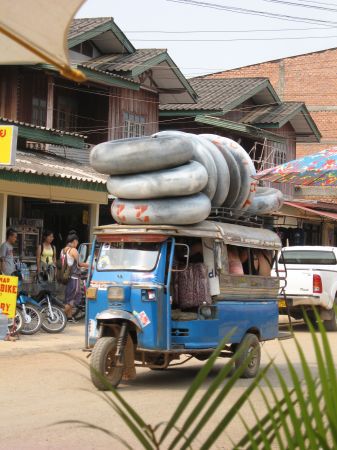 ein Tuktuk befoerdert die Tuber und Tubes flussaufwaerts