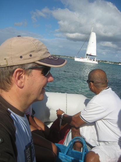 Mit einem Schlauchboot wird vom Strand auf den Katamaran übergesetzt
