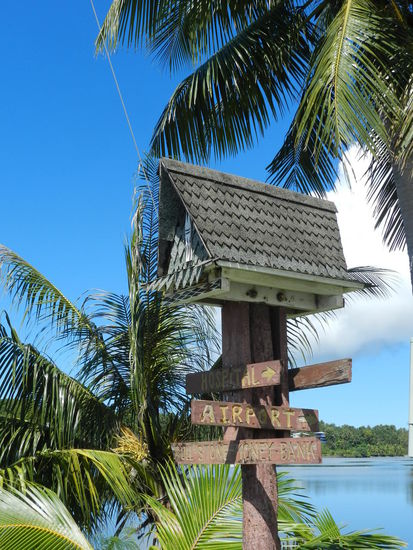 Hinweisschilder an Straßenkreuzungen sind originell unter Miniaturbaihäusern angebracht