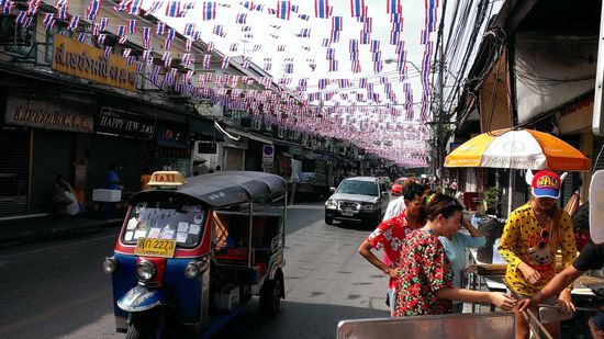 Die Stadt hat sich für das Festival ordentlich herausgeputzt. 
Im Vordergrund ein hier berühmt-berüchtigtes Tuk-tuk, bei dem man wenn man beim Mitfahren nicht aufpasst immer wieder beschissen wird.