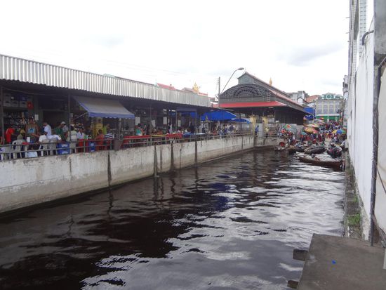 im Hintergrund die Hallen und das Gewusel von Menschen und Booten