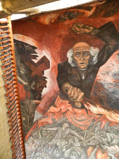 ein Ausschnitt aus dem Gemälde - Das Bild zeigt den Revolutionär Miguel Hidalgo, mit der Fackel in der Hand. Zu seinen Füssen kämpfen die Massen gegen die Bürden des Kommunismus und des Faschismus.