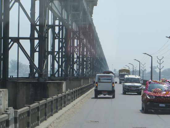 Über eine Brücke, ein geschmückter Hochzeitswagen begegnet uns.