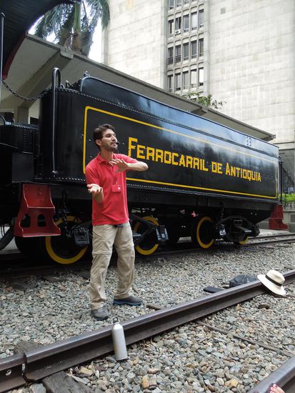 Pablo in Action - mit Wasserflasche und Sombrero auf dem Gleis markiert er einen bestimmten Abschnitt 
in der Entwicklung der Paisa-Kultur.