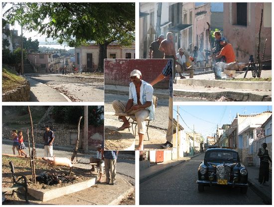 auf einem der vielen kleinen Plätze wird zum Feiertag ein Spanferkel gegrillt - man beachte den Drehmechanismus