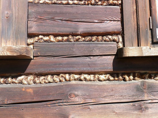 mit Strickabdichtung zwischen der Holzbalken