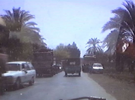 die Strasse ist voll mit LKWs, Transportern, Eselskarren und Fußgängern