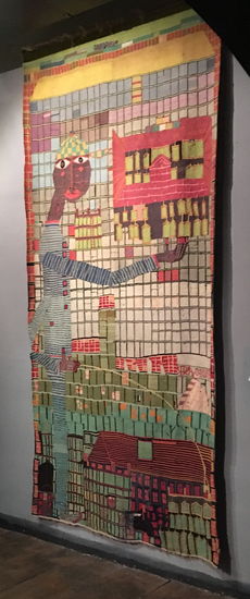 pinkelnder Knabe vor Hochhaus - ein Wandteppich