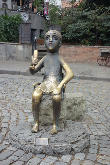 der 'tamada- am Beginn der Ausgehmeile trinkt auf 'ex', denn er kann das traditionelle Trinkhorn nicht absetzen - Vorlage war eine bei Ausgrabungen gefundene kleine bronzene Statuette