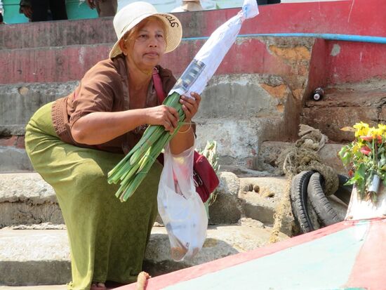 ... und beobachtet dabei die Blumenverkäuferin, die Gladiolen für 100 THB verkauft.