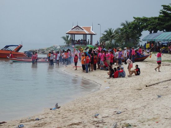 Von den beiden gerade aktiven Teams stehen die Fans direkt am Wasser, brüllen laute Anfeuerungsrufe und entzünden Chinakracher.