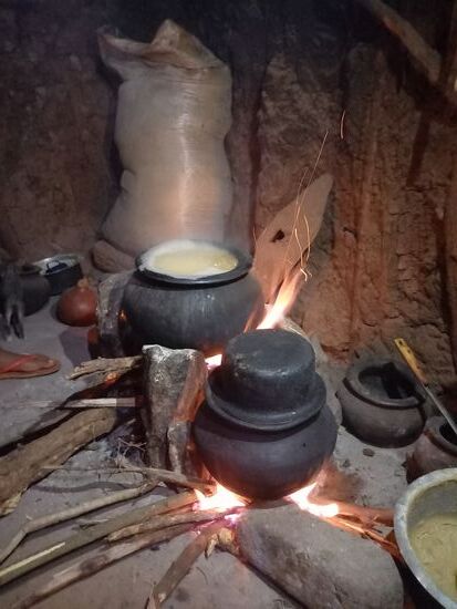 Die Kochstelle der Familie. In der Hütte ist es stock dunkel und rauchig. Direkt neben der Feuerstelle befindet sich das Bett für die Nacht.