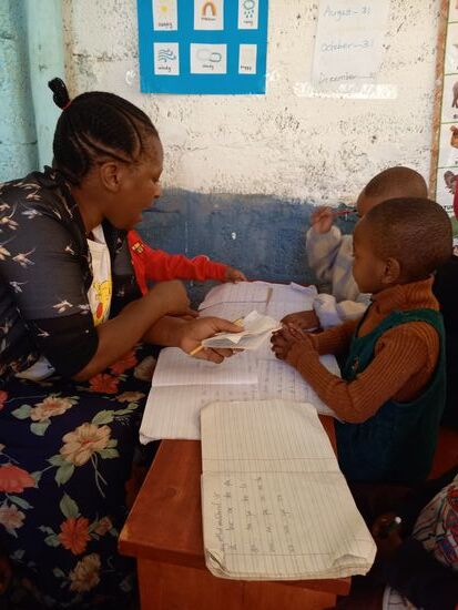 Die Lehrerin arbeitet mit den Kindern in Gruppen um sie altersgerecht zu fördern.