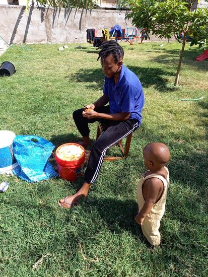 Mwema schält fleißig Kartoffeln für die Pommes.