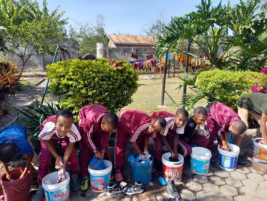 Im hinteren Teil der Schule waschen die älteren Kinder ihre Schuluniform.
