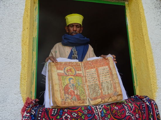Ein Priester zeigt die Heiligtümer.