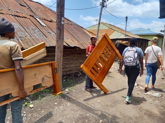 Das Bett wird ruck zuck zerlegt und dann tragen es drei Männer in Hajinas Raum.