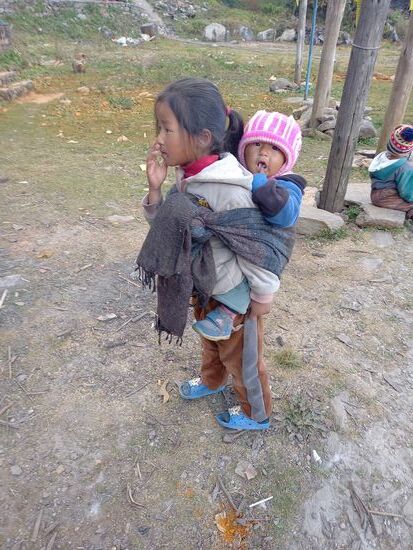 Die Kleine ist höchstens vier Jahre alt und trägt schon das Geschwisterkind.