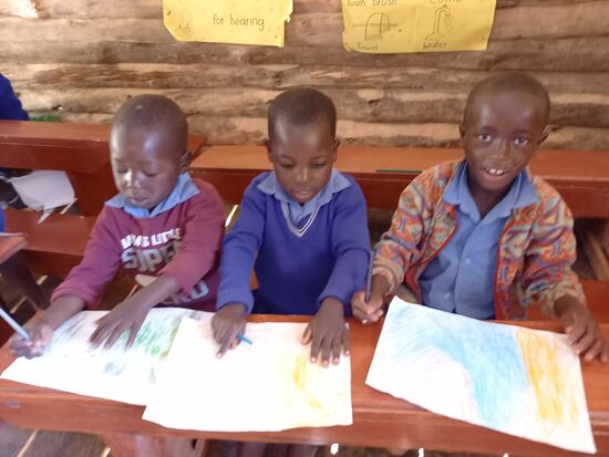 Die Kinder sind stolz auf ihre Gemälde.