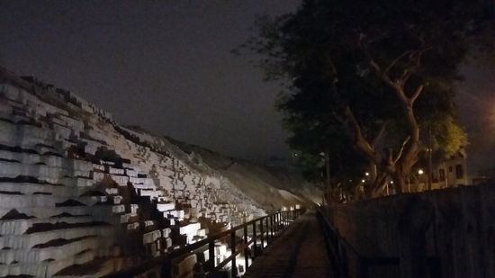 Die Ausgrabung der Pyramide ist noch nicht komplett abgeschlossen. Weiter hinten sieht man ihren ursprünglichen Zustand vor der Ausgrabung. Rechts von den Bäumen verläuft direkt eine Straße.