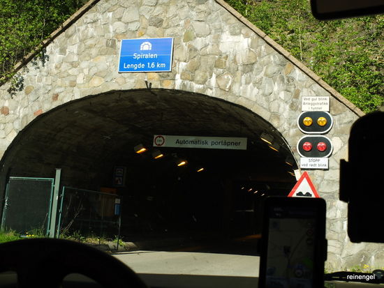 Einfahrt einer ungewöhnlichen Bergauffahrt im Berg. Die sogar mit einem WoMo befahrbare Rampe ist spiralförmig in den Fels gesprengt und endet 150 m höher oberhalb Drammens an der Bergflanke. Der gewundene Tunnel wurde nicht etwa als besondere Verkehrsverbindung gebaut, sondern diente Ende der 1950er Jahre lediglich der Gewinnung von Baumaterial, dass man zur Schonung der schönen Landschaft um Drammen einfach aus dem Berg gewann. Heute dient er vor allem auch uns als lokale Sehenswürdigkeit und als Ausgangspunkt für Wanderungen in die umliegenden Wälder.