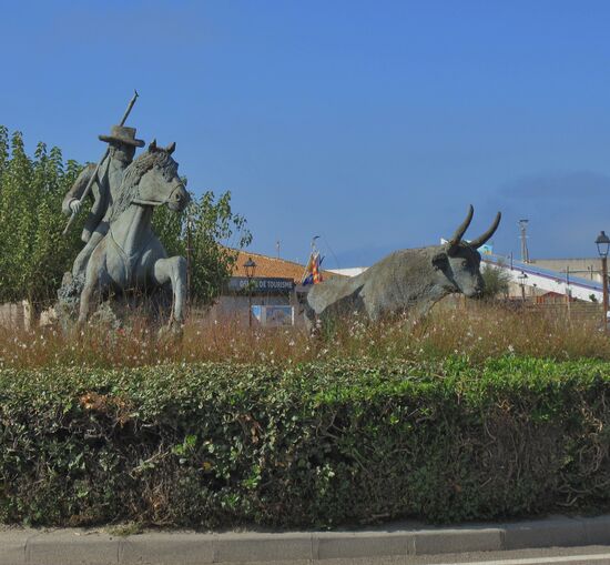 Die eindrucksvolle Skulptur mit Namen "Camargue" steht in einem Rondell im Zentrum von Saintes-Maries-de-la-Mer. Die Skulptur stellt einen Reiter auf einem Camargue Pferd und einen Camargue Stier (Taureau) dar.