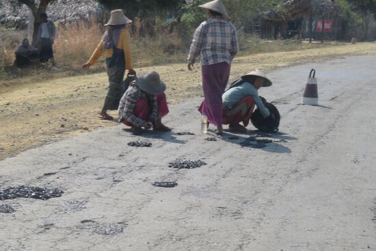 Vor allem Frauen treffen wir bei der schweren Arbeit an. Hier wird eine Straße in Handarbeit erweitert.