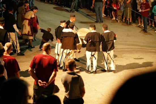 die Musiker, die mit dröhnenden Trommelschlägen und disharmonischen Flötenklängen zu den Feierlichkeiten beitragen