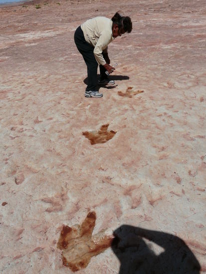 Die Indianerin schüttet Wasser in die Fußspuren, damit man sie besser sehen kann
