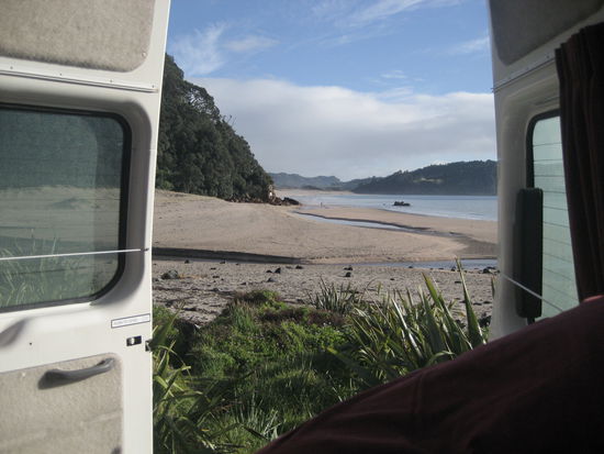 blick aus dem camper am naechsten morgen. als wir nachts ankamen hoerten wir nur das meer rauschen und morgens fanden wir dann diesen ausblick. doch es kommt noch doller...