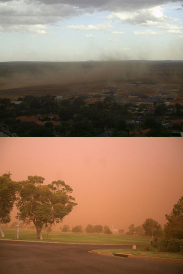 Die Stadt wird durch den Sandsturm in ein orange-rot gefärbt