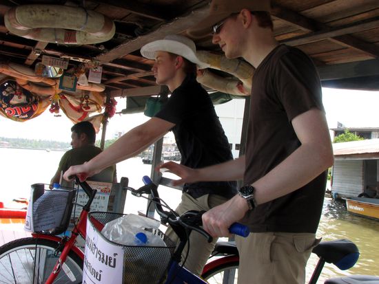 two guys with bikes on a boat