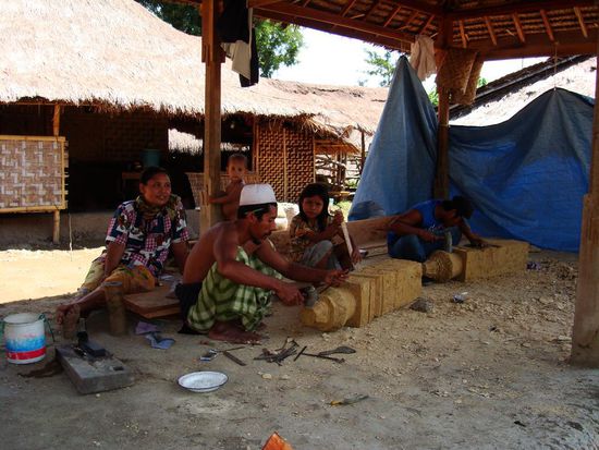 Maenner beim verzieren der Steinsaeulen fuer eine Grabstaette.