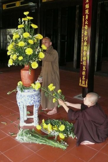 Mönche dekorieren den Schrein mit Blumen.