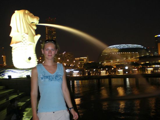 Hier stehe ich vor dem Merlion (halb Loewe halb Fisch), Singapurs Wahrzeichen.
Im Hintergrund (hell beleuchtet) sieht man das Theater.