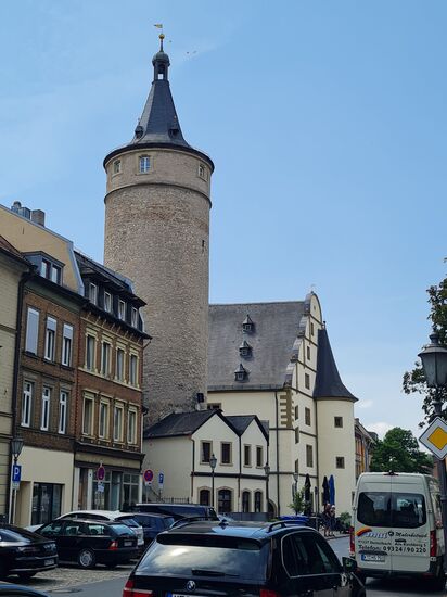 Der Marktturm von Kitzingen.
Er ist 39 m hoch, stammt aus dem 13.-14. Jahrhundert und war Teil der inneren Stadtbefestigung des 1280 erstmals als Stadt erwähnten Kitzingen.
Hier rechts vom Turm schließt sich das Rathaus an.