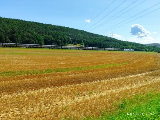 Im Schlepp haben die beiden Loks einen langen, hier nicht komplett erfassten Autotransportzug mit geschlossenen Wagen.