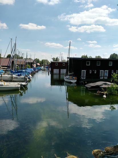 Im Hintergrund entspringt vom Starnberger See dessen einziger Abfluß, die Würm. Diese gab bis 1962 dem Starnberger See den Namen "Würmsee", weshalb sich der an dieser Stelle hier ansässige Segel-Club Würmsee Starnberg e.V. auch noch an diese Namensbezeichnung anlehnt.