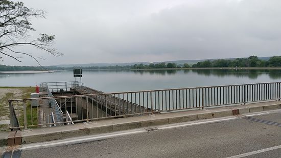 Unweit der ersten Unterkunft in Bertoldsheim geht es bald nach der Abfahrt von dort am Laufwasserkraftwerk Bertoldsheim, das mit einer Leistung von 18,9 MW mittels dreier Kaplanturbinen nur Bahnstrom liefert, auf die Donausüdseite mit Blickrichtung stromaufwärts über das weitläufige Staugebiet vor dem Wehr gleich unterhalb der Straße.