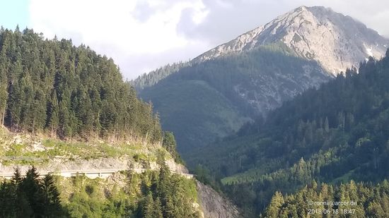 Unterhalb der bewaldeten Bergflanke auf der gegenüberliegenden Lechseite erkennt man die Trasse der "Bschlaber Landesstraße", die von Elmen über das 1894 m ü. A. hohe Hahntennjoch mit 29 km Länge nach Imst führt und somit das Tiroler Lechtal mit dem oberen Inntal verbindet.
Dies ist auch die weitläufige Ausweichstrecke, wenn im Winter wegen Lawinengefahr die Strecke zwischen den Ortschaften Lech und Warth, die auf meiner heutigen Strecke lagen, gesperrt ist.