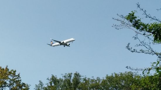 Nicht mehr weit vor Freising werden die beiden Einflugschneisen der zwei Lande- bzw. Startbahnen des Flughafens München gekreuzt. Hier befindet sich ein Jet mit bereits ausgefahrenem Fahrwerk aus Richtung Westen nicht mehr weit vor der Landebahn.