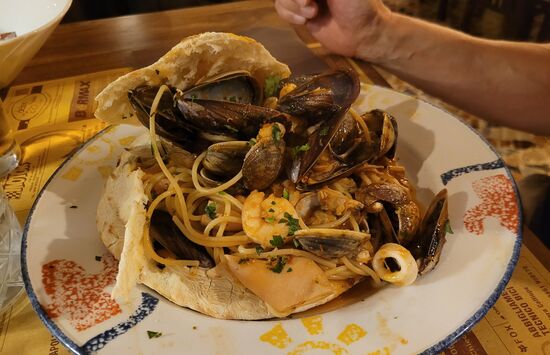 Abendessen in der Pizzeria "Millienium": Spaghetti mit Meeresfrüchte im Fladenbrot für Manni
