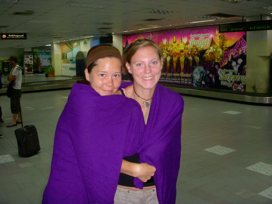 Als wir am Flughafen in Phuket ankommen, ist die Klimaanlage so eiskalt, dass meine ausgeliehene Airlinedecke uns zu Gute kommt 