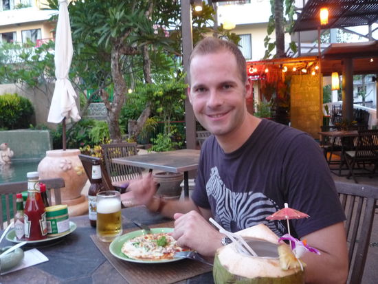 Hannes musste sich schon anstrengen fuer dieses Foto zu lachen, denn seine heiss ersehnte Pizza war nicht nur klein, sondern auch teuer u die schlechteste die er je gegessen hat. Dafuer schmeckte die Kokosmilch.