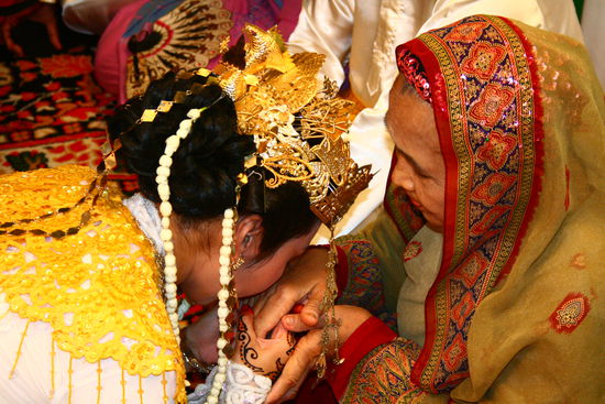 Die Braut kuesst die Hand ihrer Schwiegermutter