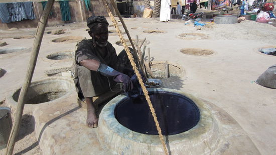 Ein Arbeiter vor einem Indigo-Färbeschacht
