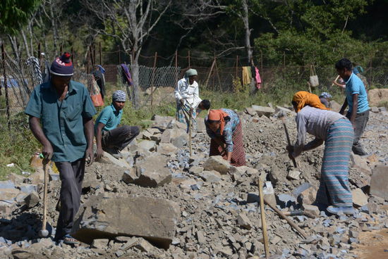 Hier wird fast alles von Hand erledigt. Erst einmal müssen die großen Steine zu Schotter zerkleinert werden