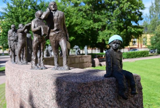 Kunst am Bau in Oulu - und irgendein Banause hat dem kleine Kerl am Ende der etwa 30köpfigen Reihe eine Mütze gehäkelt 