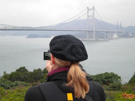 Caro infront of a bridge like the golden gate bridge in san francisco...